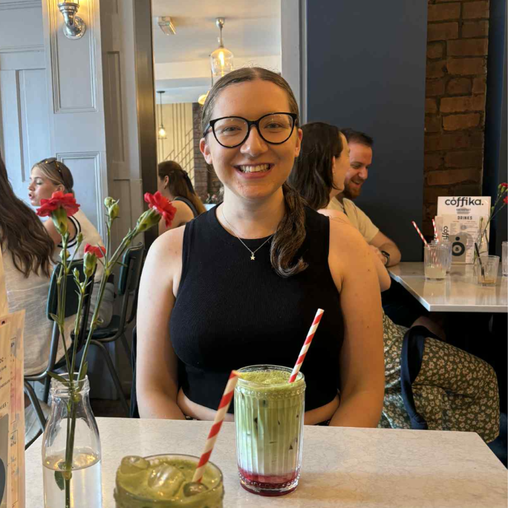 young woman with a strawberry matcha in front of her